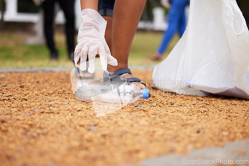 Image of Volunteer hands, bottle and woman cleaning garbage, pollution or trash waste for environment support. Community recycling, NGO charity and eco friendly people help with nature park plastic clean up