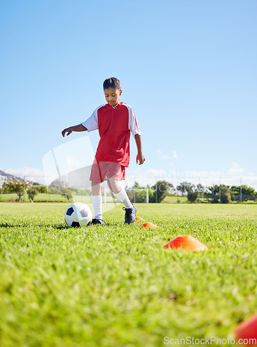 Image of Football girl kid, grass and training for fitness, sports or balance with talent development, control or speed. Female child, fast football dribbling and exercise feet on field with strong mindset