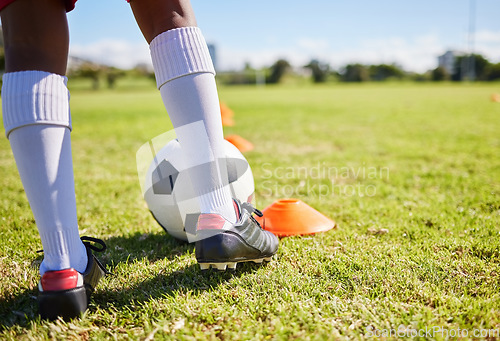 Image of Closeup football kid, grass and training for fitness, sports and balance for control, speed and development. Young soccer player, fast dribbling or exercise feet on grass with cleats in low angle