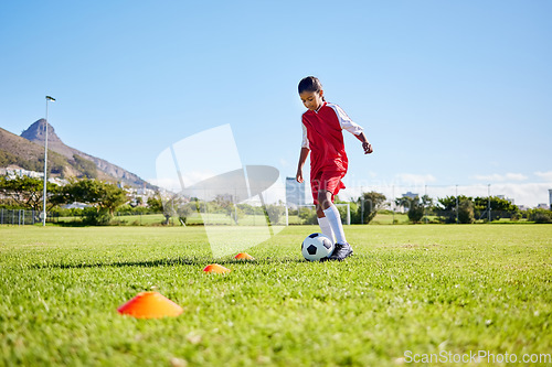 Image of Football girl kid, training and grass for fitness, speed or balance with sport talent development, control and speed. Female child, fast football dribbling or motivation mindset on field in Cape Town