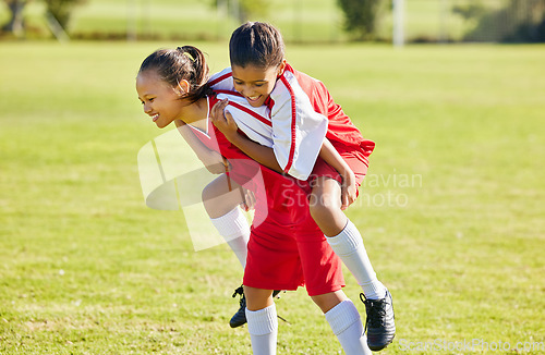 Image of Girl soccer player, happy celebration and grass with piggyback for goal, teamwork and winning contest. Young female kids, winner and celebrate with support, solidarity and happiness at soccer field