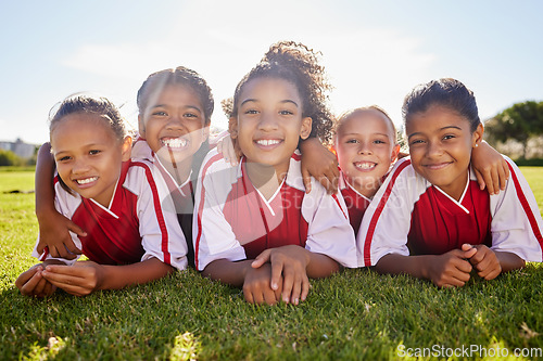 Image of Girl, soccer group portrait and lying with smile, team building happiness or solidarity to relax at training. Female kids, sports diversity and happy with friends, teamwork or development in football