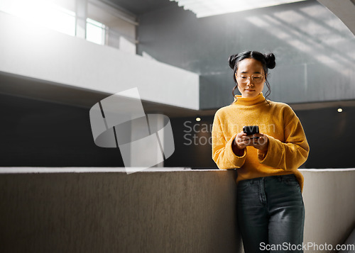 Image of Woman, phone and texting in office building, relax and calm while on internet, search and reading. Asian, girl and business entrepreneur with smartphone for research, office space or idea in Japan