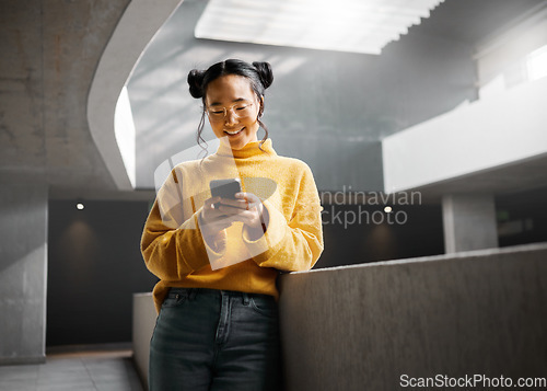 Image of Happy, woman and texting on phone in office building, relax while on internet, search and reading. Asian, girl and business entrepreneur with smartphone for research, office space or idea in Japan