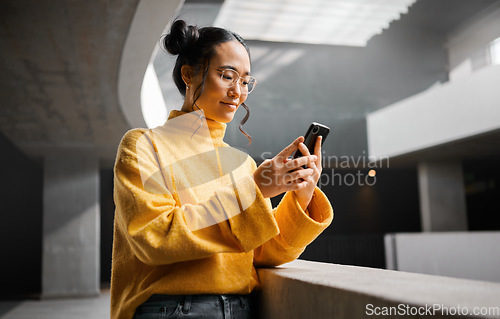 Image of Woman, phone and texting in office building, thinking and calm while on internet, search and reading. Asian, girl and business entrepreneur with smartphone for research, office space or idea in Japan