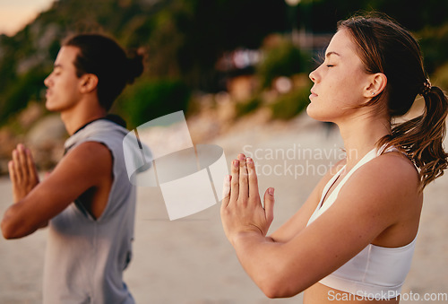 Image of Meditation, prayer hands and yoga couple at beach outdoors for health and wellness. Zen chakra, pilates fitness and man and woman with namaste hand pose for praying, training and mindfulness exercise