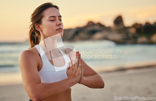 Image of Meditation, yoga prayer hands and woman at beach outdoors for health or wellness. Sunset, zen pilates and female yogi with namaste hand pose for praying, training or mindfulness exercise at seashore