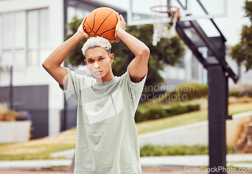 Image of Basketball, young man and basketball player with sport in park with portrait in city and exercise outdoor. Fitness, athlete on basketball court, focus and urban with sports motivation and training.