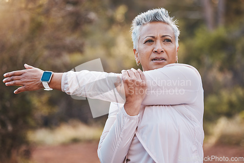 Image of Exercise, stretching and senior woman outdoor in nature for running, cardio fitness and a workout with a smartwatch. Elderly female in a forest for cardio training for a healthy lifestyle and body