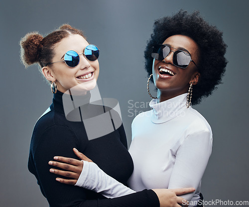 Image of Fashion, futuristic and women smile in sunglasses, cyberpunk and trendy designer brand with gen z youth. Marketing, diversity and contemporary style with vision and edgy against studio background