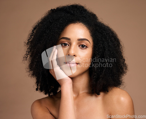 Image of Beauty, black woman and hair care portrait for luxury hair cosmetics or skincare wellness in brown background studio. Young African model, healthy and natural waves hairstyle or dermatology treatment