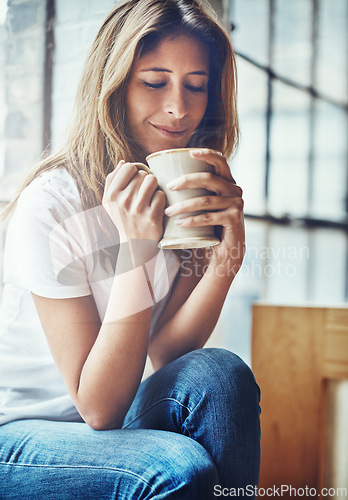 Image of Calm, coffee and woman smelling the aroma while relaxing in her home on a weekend morning. Happy, relax and female from Columbia smell the caffeine scent while enjoying a hot drink in her house.