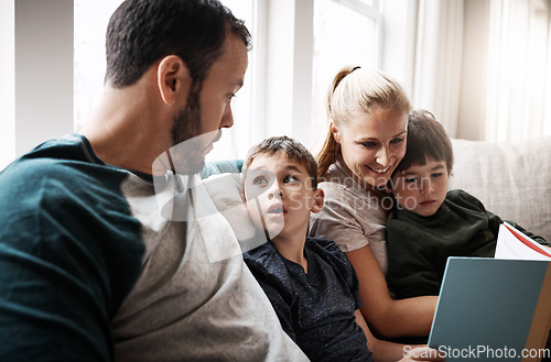 Image of Man, woman and kids on sofa with book learning to read at storytelling time in living room of home. Love, family and couple with children, books and child development on couch in apartment together.