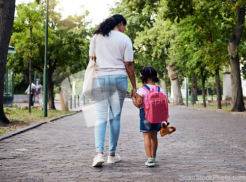 Image of Mother, child and walking with backpack holding hands to school for safety at the outdoor park. Mom with little girl or daughter having a walk together for safe travel, trip or care for childhood