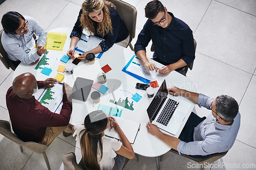 Image of Meeting, discussion and top view of a team planning in a company report or proposal in the office. Teamwork, diversity and marketing employees working on a creative project together in the workplace.