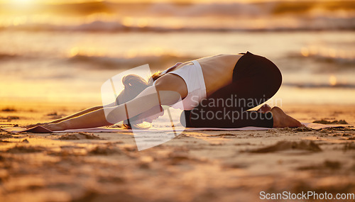 Image of Beach, yoga child pose and woman stretching for health, fitness and wellness. Sunset pilates, zen chakra and young female yogi exercise, workout or meditation training at seashore outdoors alone.