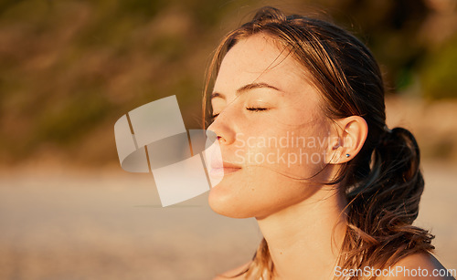 Image of Face, relax and meditation with a woman outdoor in nature, standing alone for zen, calm or serenity. Mindset, peace and mental health with an attractive young female breathing outside for mindfulness