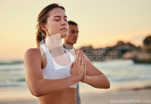 Image of Zen, woman and on beach for meditation, exercise and peace for balance, workout and healthy lifestyle. Female, girl and yoga practice, seaside and hands together for calm, relax and fitness training