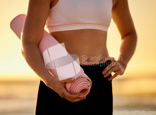 Image of Yoga mat, closeup and woman at a beach for meditation, zen and relax for wellness, exercise and health. Fitness, zoom and girl at the sea for yoga or pilates, breathing and calm before ocean workout