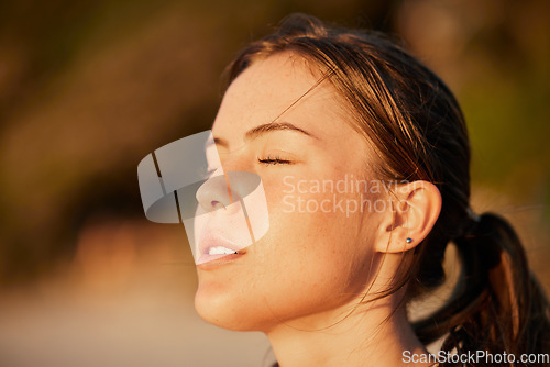 Image of Face, meditation and peace with woman outdoor in nature, standing alone for zen, calm or serenity. Relax, wellness and mental health with an attractive young female breathing outside for mindfulness