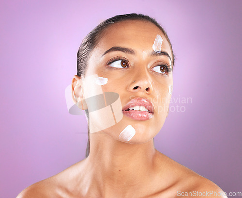 Image of Woman face, skincare and beauty cream or lotion for dermatology, health and wellness of natural glow skin on purple background. Headshot of aesthetic cosmetics model in studio with sunscreen product