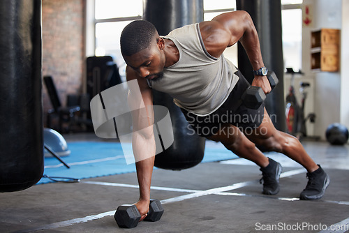 Image of Black man, fitness and muscle training with dumbbells in gym, exercise with balance and strong athlete, push up and focus. Sports, bodybuilder power and wellness with health and active lifestyle