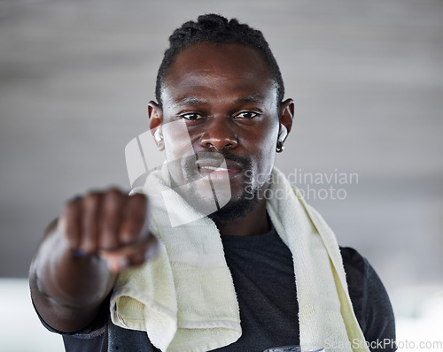 Image of Black man, boxing and fist with fitness portrait, sports and martial arts with exercise and earphones for music. Athlete, boxer and MMA fighter with towel, workout and training with audio streaming