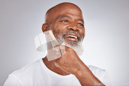 Image of Elderly, black man with comb for beard, beauty and grooming with hygiene and cosmetic care against studio background. Hair care mockup, brush body hair and face with hair treatment and cosmetics