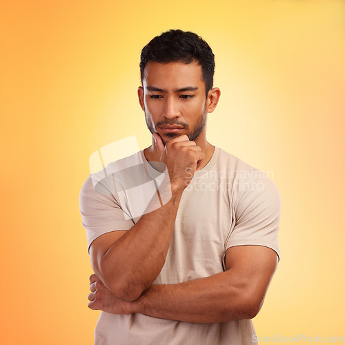 Image of Thinking, sad and curious Asian man with a decision isolated on a yellow background in a studio. Depression, mental health and depressed Japanese person with a problem, choice or idea on a backdrop