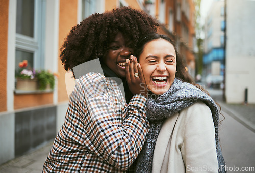 Image of Friends, gossip in ear and women in street laughing at secret joke in city with smile on face. Urban secrets, rumor and whisper in ears, black woman with friend laugh at funny story on walk in town.