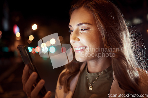 Image of Happy woman, face or phone in city night, road or street on social media, taxi call or cab search in Dubai location. Smile, student or tourist person on mobile communication technology in dark travel
