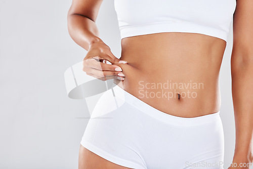 Image of Woman, stomach and weight wellness in lingerie for healthcare, skincare beauty or body training in white background. Model, tummy tuck or gut health for exercise motivation or abdomen nutrition diet