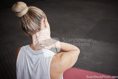 Image of Neck pain, fitness and woman with injury in a gym after intense physical training or exercise. Medical emergency, sports accident and female athlete with sore, ache and swollen muscle in sport center