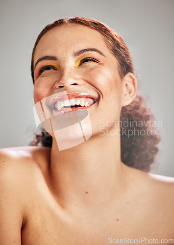 Image of Beauty eyeshadow, studio face and happy woman with creative cosmetics makeup, skincare glow and luxury self care. Facial cosmetology, spa salon and aesthetic model smile isolated on grey background