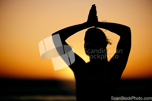 Image of Prayer hands, meditation and silhouette of woman at sunset outdoors for health and wellness. Pilates fitness, zen shadow and female yogi with namaste hand pose for chakra, training and yoga exercise.