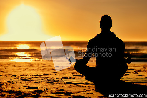 Image of Lotus, yoga and silhouette of man at beach outdoors for health and wellness. Sunset, zen meditation and shadow or outline of male yogi meditating, chakra training and mindfulness exercise at seashore