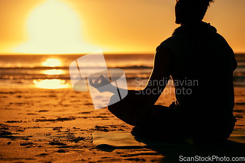 Image of Meditation, lotus and silhouette of man at beach outdoors for health and wellness. Sunset, zen yoga and shadow or outline of male yogi meditating, chakra training and mindfulness exercise at seashore