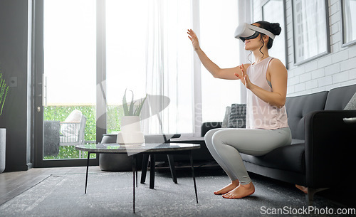 Image of VR, metaverse and futuristic with a woman in the living room of her home using a headset to access a 3d game. Technology, virtual reality and gaming with a female gamer using ai to play games