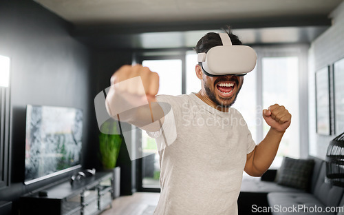 Image of VR, angry and man boxing with glasses, training for a fight and match. Futuristic, digital sports and gamer punching while playing in an augmented reality game online with technology in a house