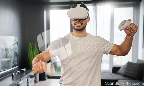 Image of Man, video gaming and virtual reality glasses for playing esports, controller and online game to relax. Vr, gamer or male with hobby, digital design and innovation for fun, futuristic and technology