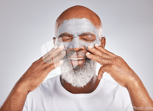 Image of Skincare, hands or old man with facial cream marketing or advertising luxury beauty product for self care. Studio background, cosmetics or elderly black man with a happy smile applying face mask