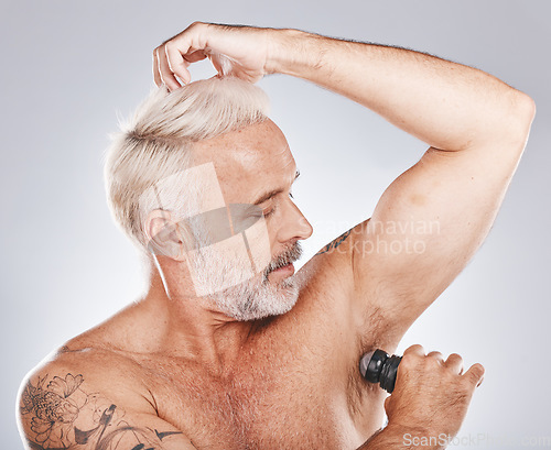 Image of Armpit, deodorant and senior man with beauty and body care, smell control and hygiene with grooming against studio background. Clean, mature model and wellness with cleaning cosmetics product