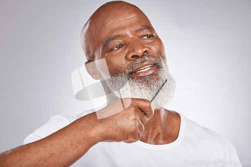 Image of Elderly, black man with comb for beard, beauty and grooming with hygiene and cosmetic care against studio background. Hair care mockup, brush body hair and face with hair treatment and cosmetics