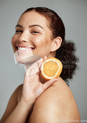 Image of Woman, studio portrait and orange for skincare, health and wellness with cosmetic glow, self care and backdrop. Model, black woman and fruit for cosmetics, diet and healthy natural skin by background