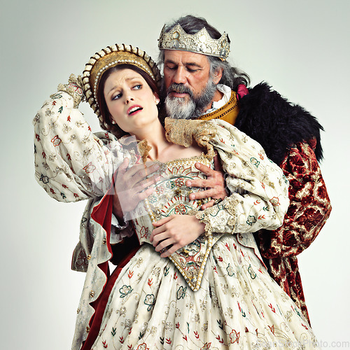 Image of Theater, king and queen in costume with violence in in crown and renaissance clothes in studio. Art, cosplay and larp, couple in medieval play, royal history character and woman in distress with man.