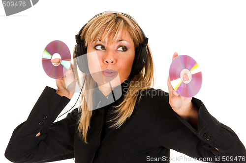 Image of woman listening music in headphones and holding two CD