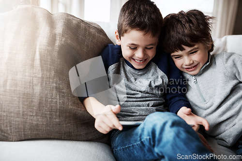 Image of Boy siblings, tablet and sofa with laugh, funny meme and digital app for gaming, streaming or comedy. Kids, couch and mobile tech on social media, video or comic movie in family home for love bonding