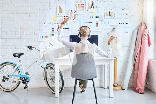 Image of Designer woman, music and desk in workshop by moodboard, relax and dance on break for inspiration. Startup fashion expert, studio and sitting at table for motivation, vision or goal with headphones