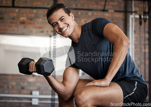 Image of Portrait, fitness and dumbbell with a sports man training in a gym for strong or healthy muscles. Happy. exercise and weightlifting with a male athlete or bodybuilder in a health club for a workout