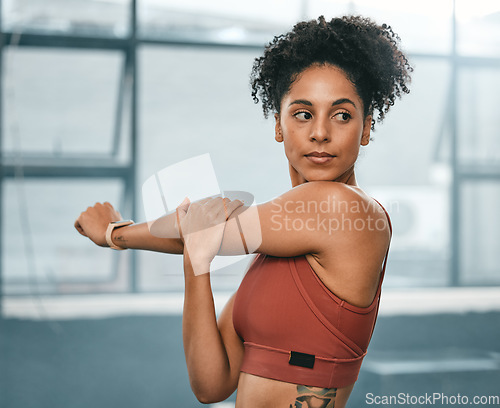 Image of Black woman, thinking and exercise stretching arms for fitness workout, wellness training or cardio runner lifestyle. African athlete, healthy warm up motivation and mindset vision in sports gym